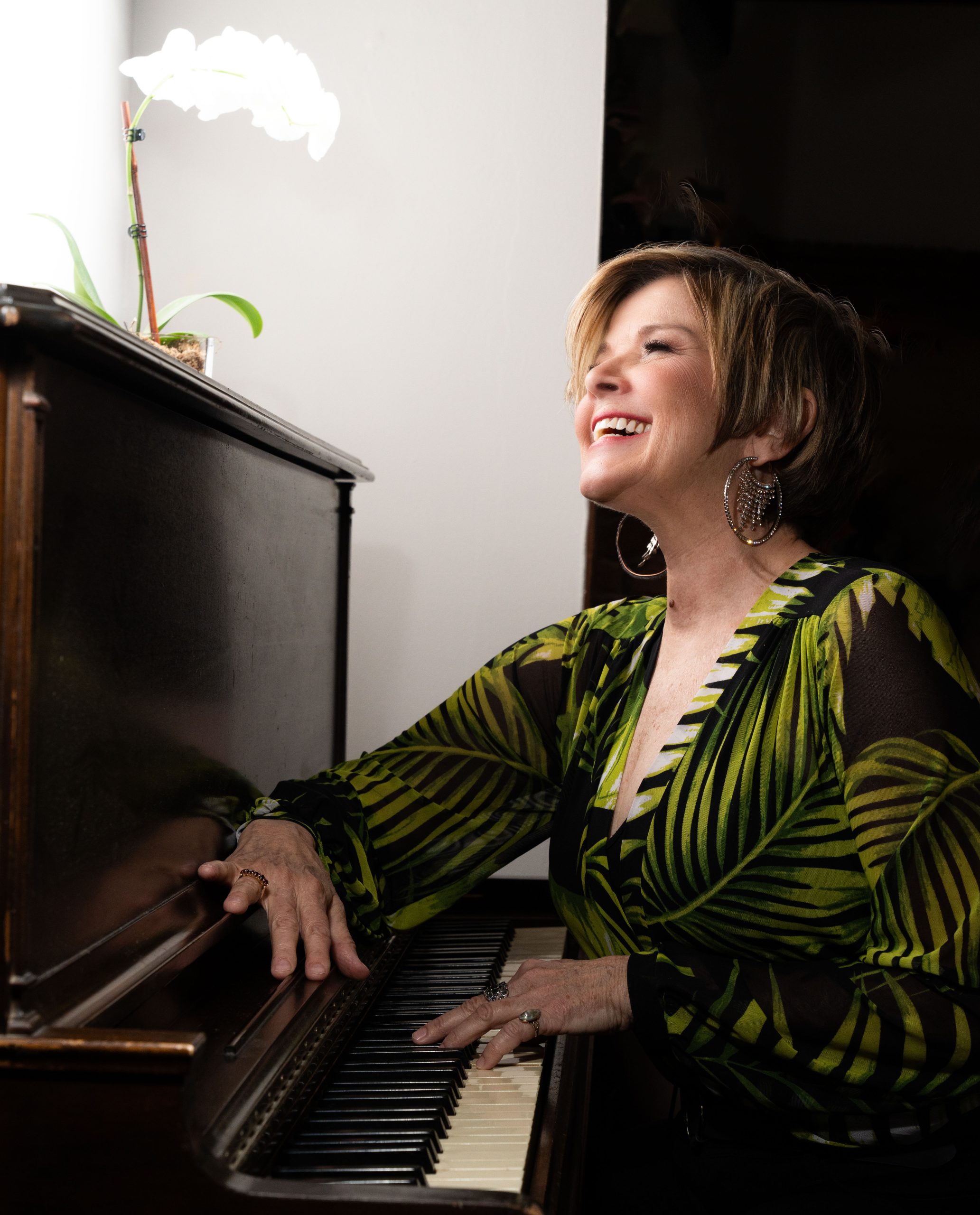 Karrin Allyson at the piano, smiling